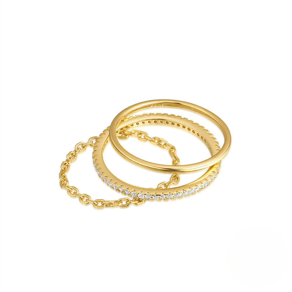 Three gold rings with different designs on a white background