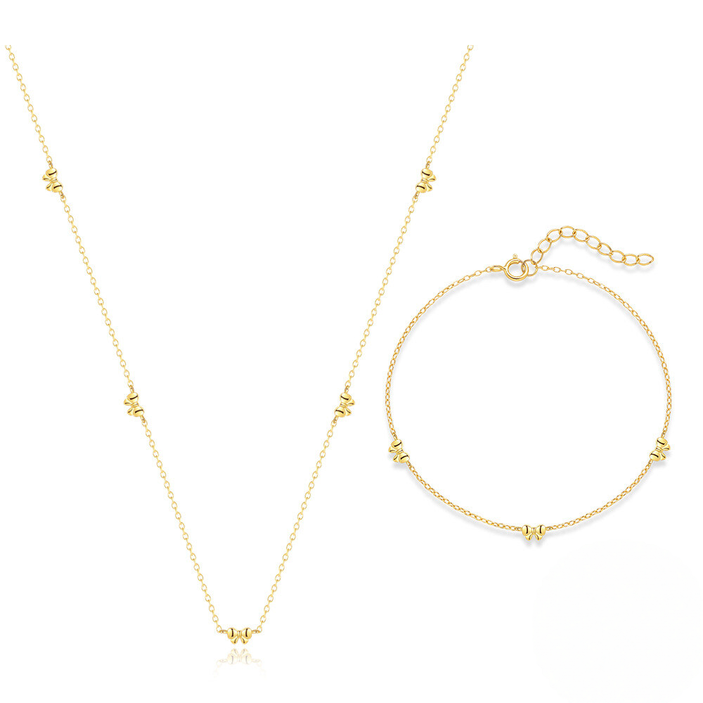 Gold necklace and bracelet set on a white background