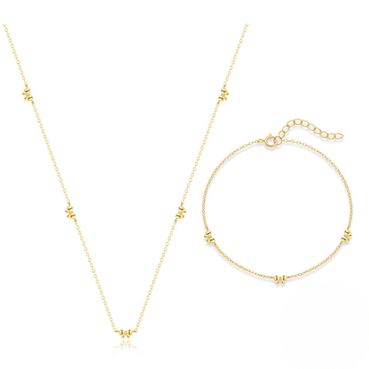 Gold necklace and bracelet set on a white background