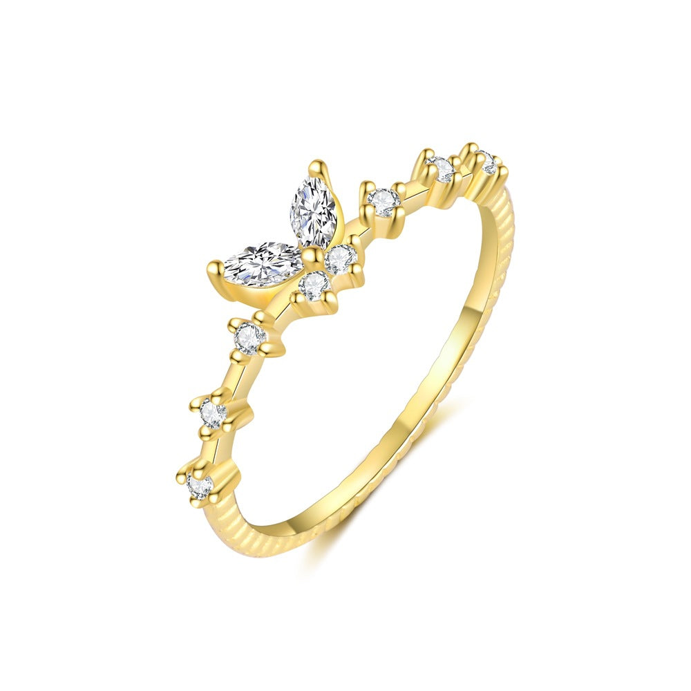 Gold ring with diamond accents on a white background