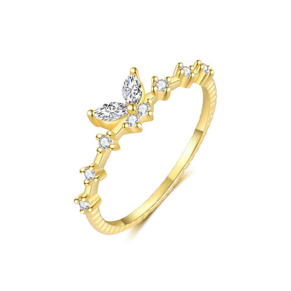 Gold ring with diamond accents on a white background