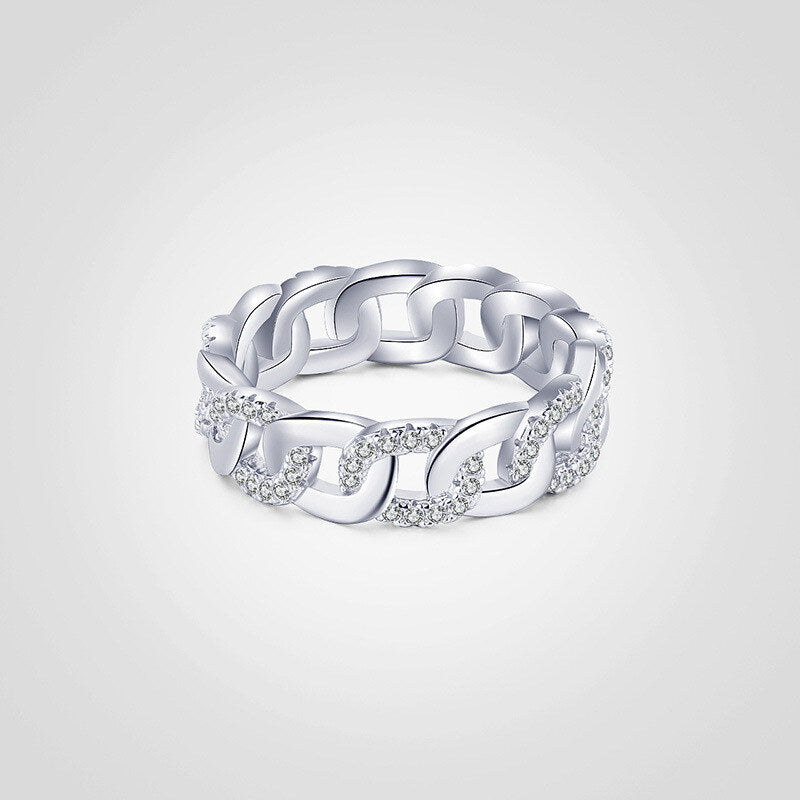 Silver chain ring with embedded diamonds on a light gray background