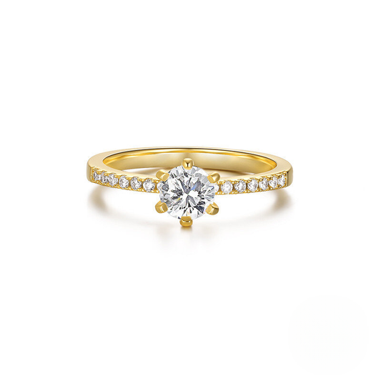 Gold ring with a diamond on a white background