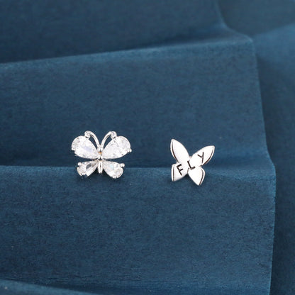 Butterfly-shaped earrings on a blue cushion