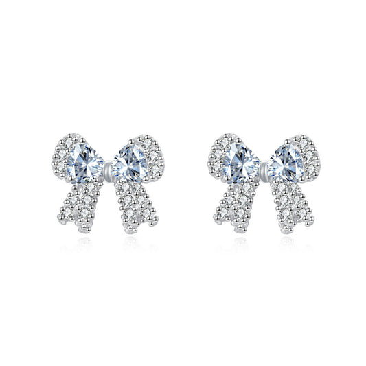 Bow-shaped earrings with clear gemstones on a white background