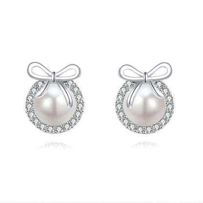 Pearl earrings with bow designs on a white background