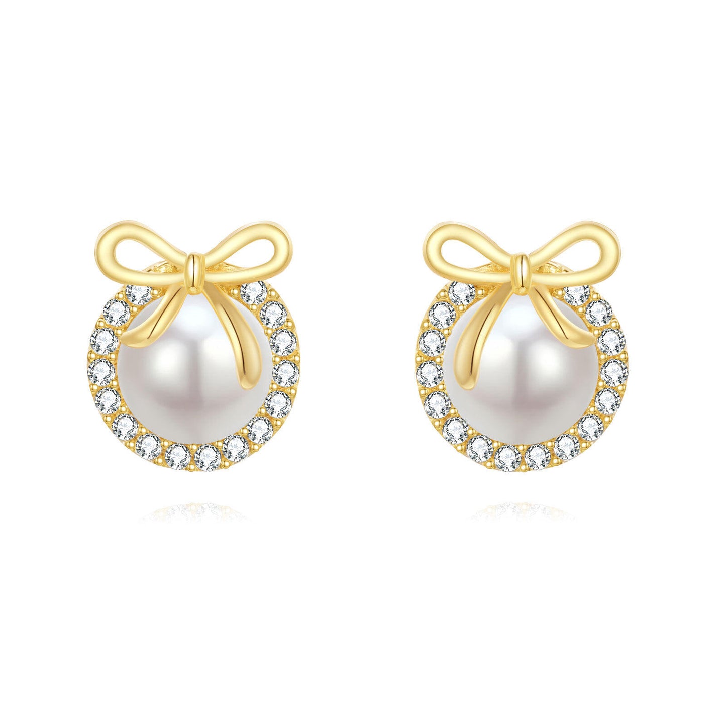 Pair of pearl earrings with gold bows and diamond accents on a white background