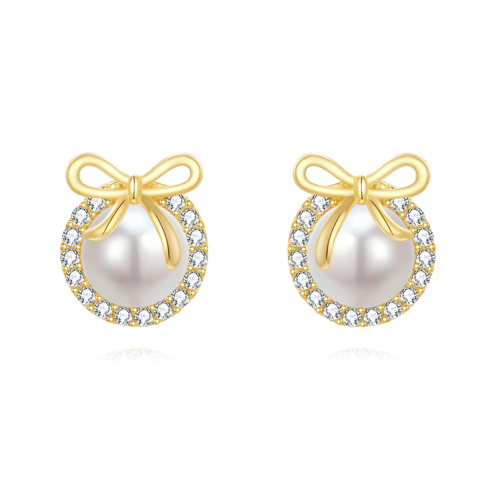 Pair of pearl earrings with gold bows and diamond accents on a white background