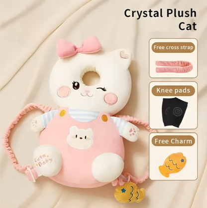 Pink plush cat toy with bow and accessories on a beige background