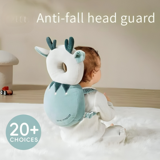 Baby wearing an anti-fall head guard with a deer design on a soft surface.