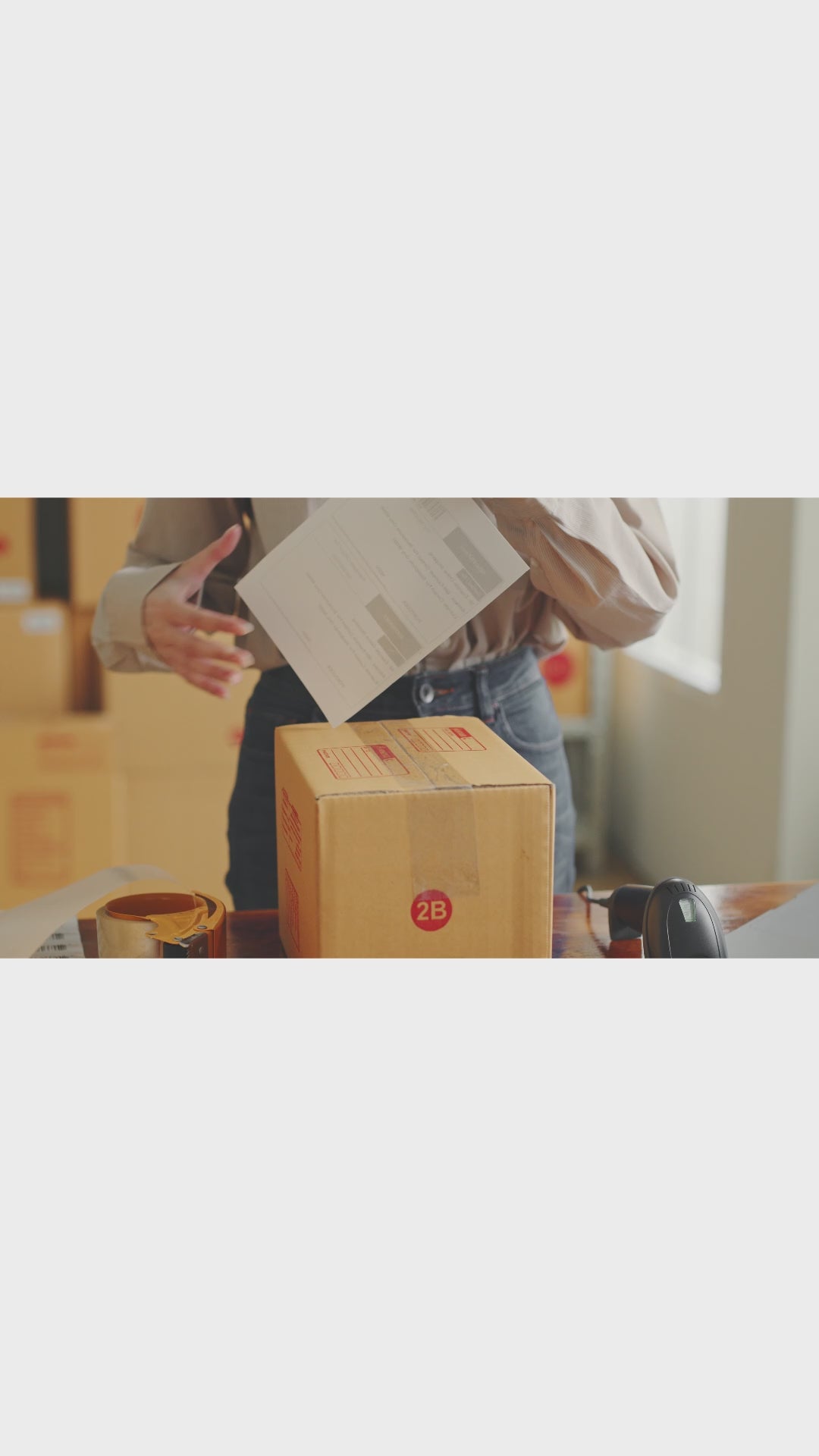 women packing an order and putting an slip on delivery box